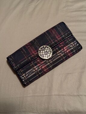 A Coach Plaid Trifold Wallet with Decorative Silver Signature Medallion
